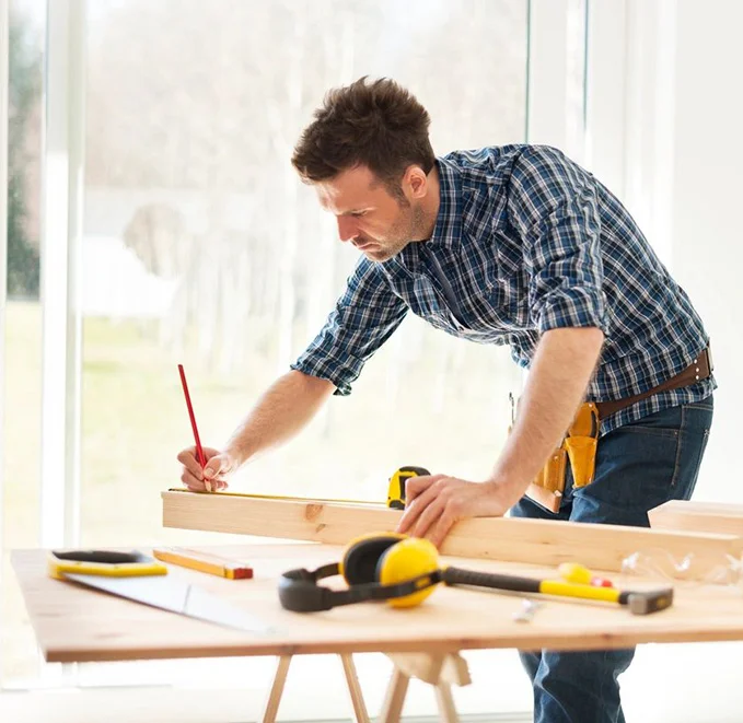 A man is working on something at the table.